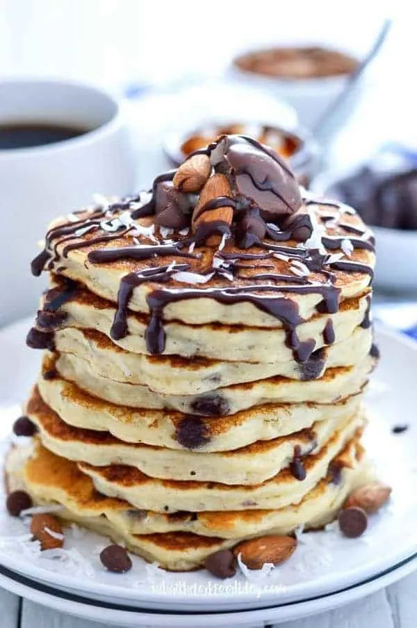 Gluten Free Almond Joy Pancakes - all the chocolate, almond, and coconut flavors of your favorite candy but in pancake form. Recipe from @whattheforkblog | whattheforkfoodblog.com