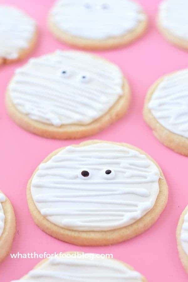 Gluten Free Mummy Cookies are a fun treat for Halloween parties. Made with gluten free and dairy free sugar cookies and an easy royal icing for decorating. Recipe from @whattheforkblog | whattheforkfoodblog.com