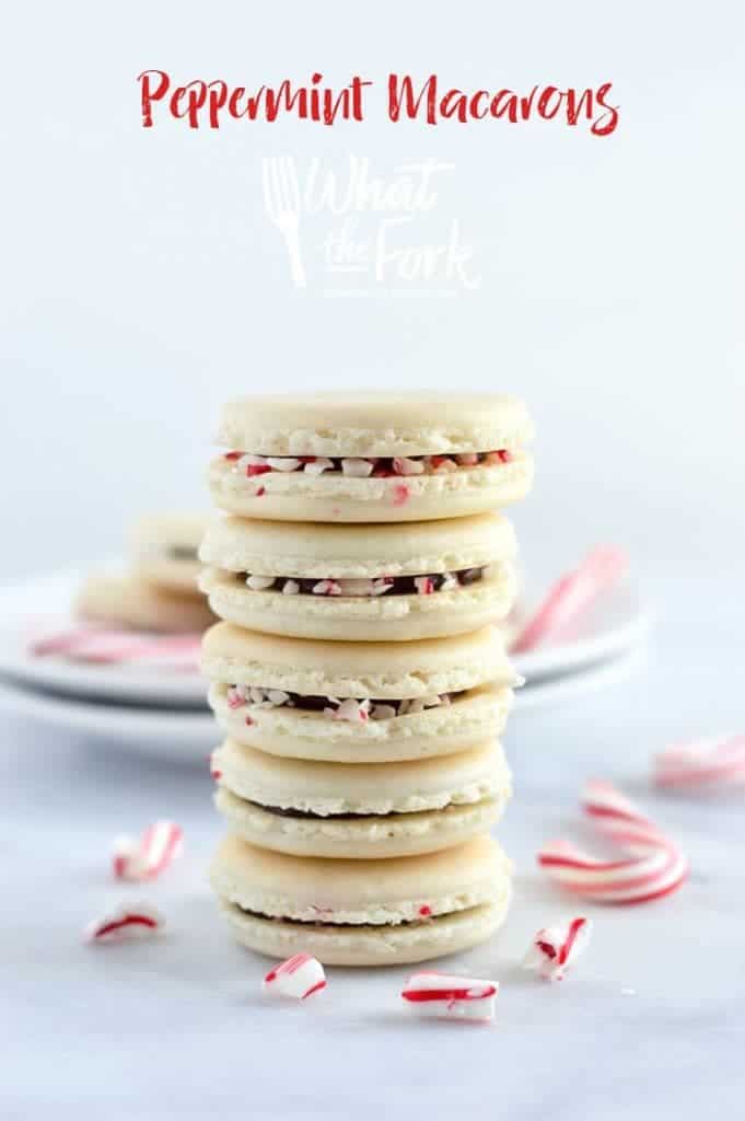 Gorgeous Macarons flavored for Christmas! These peppermint macarons are made with a basic macaron shell and filled with peppermint chocolate ganache and crushed candy canes - they’re heavenly! Gluten free and dairy free macaron recipe from @whattheforkblog | whattheforkfoodblog.com | Sponsored | how to make macarons | easy macaron recipe | french macarons | french macaron filling | french macaron flavors | macaron recipe flavors