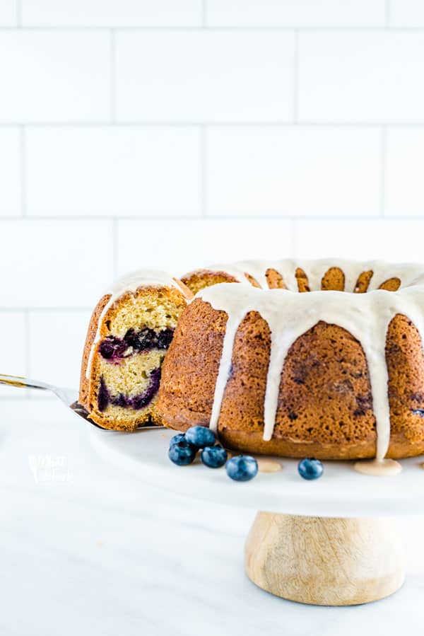 This blueberry coffee cake is one of my favorite ways to eat fresh blueberries! Itâ€™s a sour cream based coffee cake layered with cinnamon coated blueberries and it tastes out of this world amazing! Top it off with a quick cinnamon glaze or leave it plain. This coffee cake is perfect for brunch, pot lucks, parties, or dessert! Easy gluten free recipe from @whattheforkblog - visit whattheforkfoodblog.com for more gluten free baking recipes. #glutenfree #blueberry #coffeecake #cake #blueberryrecipes #baking