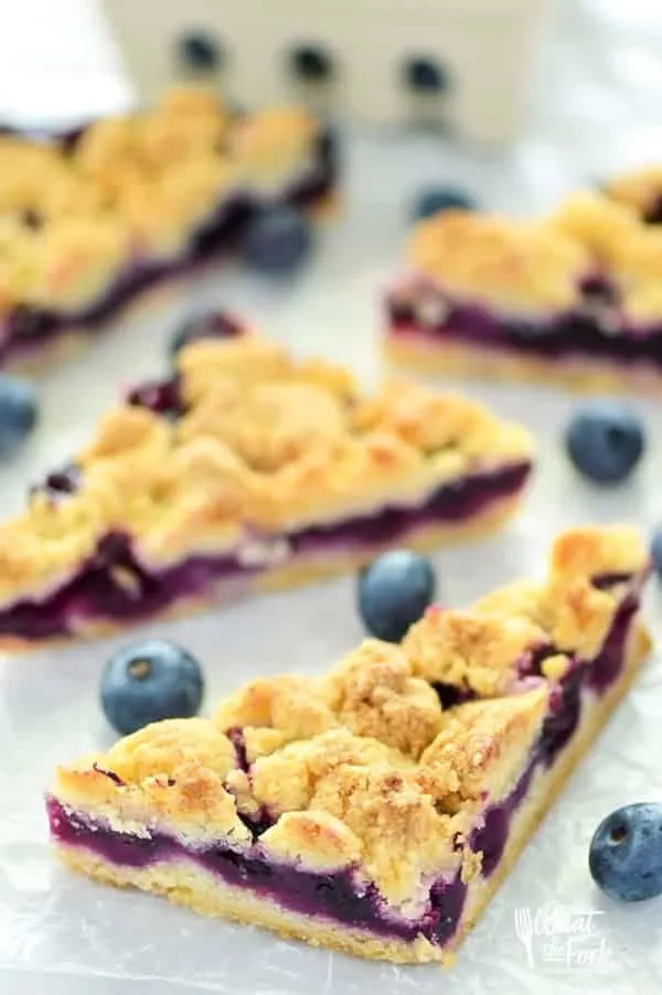 These Gluten Free Blueberry Crumb Bars are made with fresh blueberries and are a really delicious dessert or snack. The crumb is nice and crisp and the lemon zest makes these bright and fresh! Recipe from @whattheforkblog | whattheforkfoodblog.com | gluten free dessert recipes | easy gluten free desserts | summer recipes | summer desserts | recipes for fresh blueberries | fruit desserts