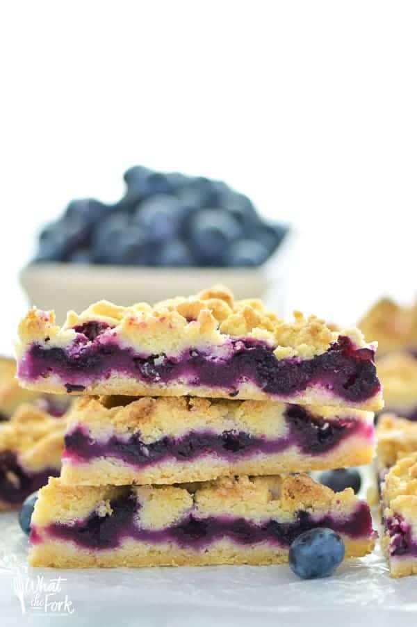 These Gluten Free Blueberry Crumb Bars are made with fresh blueberries and are a really delicious dessert or snack. The crumb is nice and crisp and the lemon zest makes these bright and fresh! Recipe from @whattheforkblog | whattheforkfoodblog.com | gluten free dessert recipes | easy gluten free desserts | summer recipes | summer desserts | recipes for fresh blueberries | fruit desserts