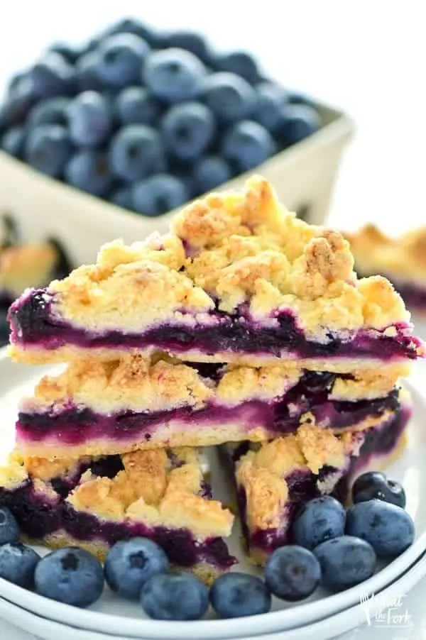 These Gluten Free Blueberry Crumb Bars are made with fresh blueberries and are a really delicious dessert or snack. The crumb is nice and crisp and the lemon zest makes these bright and fresh! Recipe from @whattheforkblog | whattheforkfoodblog.com | gluten free dessert recipes | easy gluten free desserts | summer recipes | summer desserts | recipes for fresh blueberries | fruit desserts