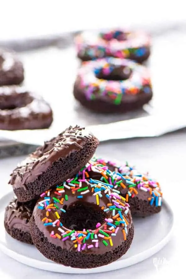 Gluten Free Baked Double Chocolate Donuts are the breakfast you've been craving! They're light and incredibly easy to make. Perfect for Saturday morning or Sunday brunch! These can easily be made dairy free too. Easy donut recipe from @whattheforkblog | whattheforkfoodblog.com | baked donut recipe | baked chocolate donuts | chocolate glaze for donuts | homemade donut recipes | #donuts #doughnuts #glutenfree #easyrecipes #breakfast #chocolate