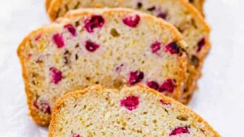 sliced gluten free cranberry orange bread on wax paper