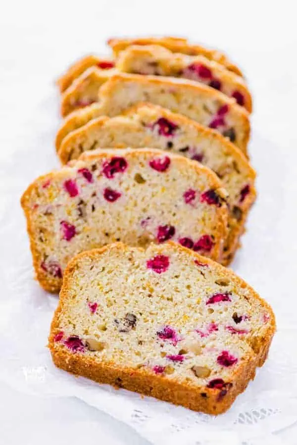 sliced gluten free cranberry orange bread on wax paper