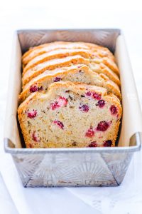 Gluten Free Cranberry Bread is the perfect holiday loaf! It’s got a dairy-free option too! It’s full of flavor thanks to orange zest and extract and fresh cranberries and can be made with dried cranberries. This gluten free quick bread is easy and simple to make. You’d never know it was gluten free! It’s great for gifting too and can be made as four mini loaves. Gluten free bread recipe from @whattheforkblog - visit whattheforkfoodblog.com for more! #glutenfree #quickbread #glutenfreebread