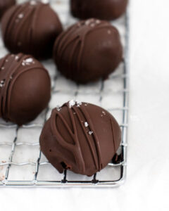 Chocolate Dipped Chocolate Truffles sprinkled with sea salt on a small wire rack