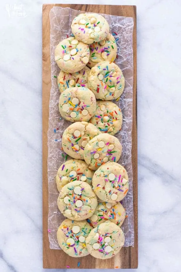 Super easy gluten free cake batter cookies! No chilling time required! Filled with white chocolate chips and loaded with sprinkles, these cookies are crave-worthy! Gluten free cookie recipe from @whattheforkblog | whattheforkfoodblog.com | homemade gluten free cookies | gluten free funfetti cookies | #sprinkles #cookies #funfetti #glutenfree #easyrecipes