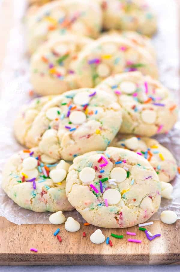 Super easy gluten free cake batter cookies! No chilling time required! Filled with white chocolate chips and loaded with sprinkles, these cookies are crave-worthy! Gluten free cookie recipe from @whattheforkblog | whattheforkfoodblog.com | homemade gluten free cookies | gluten free funfetti cookies | #sprinkles #cookies #funfetti #glutenfree #easyrecipes