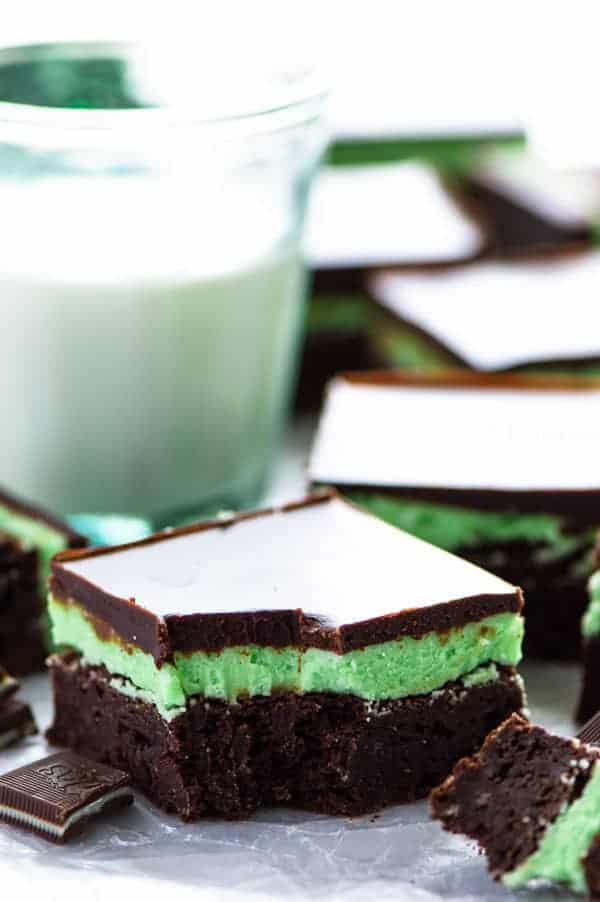 Mint Flourless Brownies topped with mint buttercream (make it with or without the green coloring) and chocolate ganache - these are a mint lover’s dream dessert! They’re really easy to make too! Recipe from @whattheforkblog | whattheforkfoodblog | gluten free brownies | homemade brownie recipe | how to make brownies without flour | mint desserts | easy dessert recipes | #glutenfree #brownies #mint #buttercream #dessert #easyrecipes #chocolate Chocolate Mint Brownies