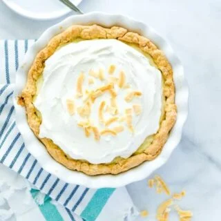 Coconut Cream Pie is a true dessert comfort food! Flaky pie crust filled with creamy coconut custard, layered with sweet fresh whipped cream and topped with toasted coconut. It’s a DREAM! Make it with a gluten free pie crust or a regular pie crust, your choice! This easy pie recipe is great for any holiday or get together. Easy dessert recipe from @whattheforkblog - visit whattheforkfoodblog.com for more! #glutenfree #pie #coconut #dessert #easydessert #recipe #dessertrecipes #coconutrecipes