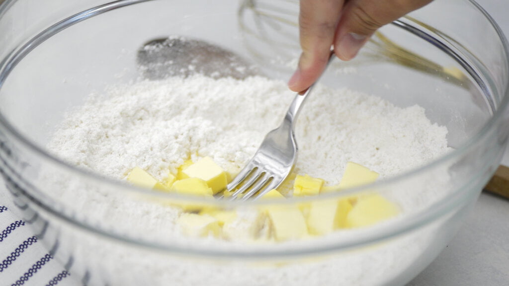 Use a pastry cutter to cut the butter into the flour mixture until it resembles coarse cornmeal.