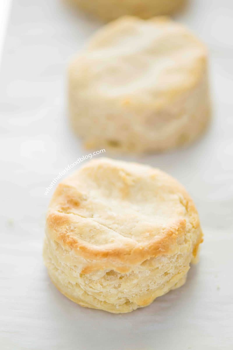 Up close shot of a golden, flaky gluten free biscuit.