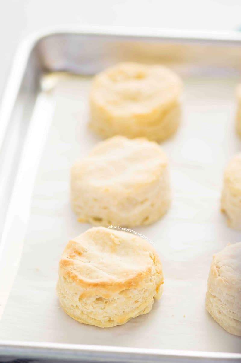 Delicious golden homemade gluten free biscuits on a sheet pan.