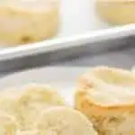 Gluten Free Biscuits on a plate with one split open to show flaky layers