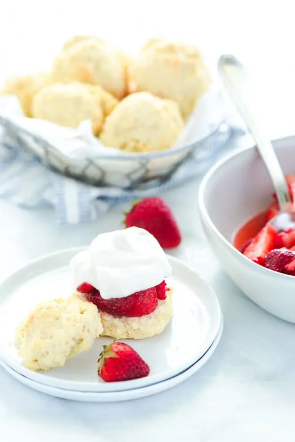 Easy gluten free strawberry shortcake is made with gluten free drop biscuits that are topped with sweetened strawberries and homemade whipped cream. It's the perfect late spring and early summer dessert during strawberry season. This recipe is best with fresh strawberries! Easy gluten free dessert recipe from @whattheforkblog - visit whattheforkfoodblog.com for more gluten free dessert recipes! #glutenfree #strawberry #strawberryshortcake #dessert #glutenfreedessert #easyrecipe