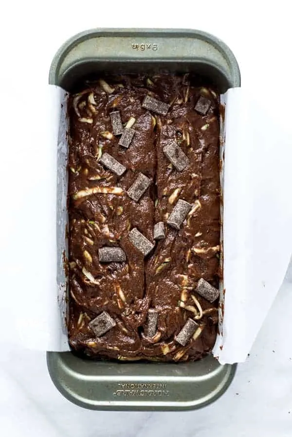 Gluten Free Double Chocolate Zucchini Bread batter in a silver loaf pan ready to be baked