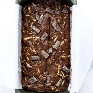 Gluten Free Double Chocolate Zucchini Bread batter in a silver loaf pan ready to be baked