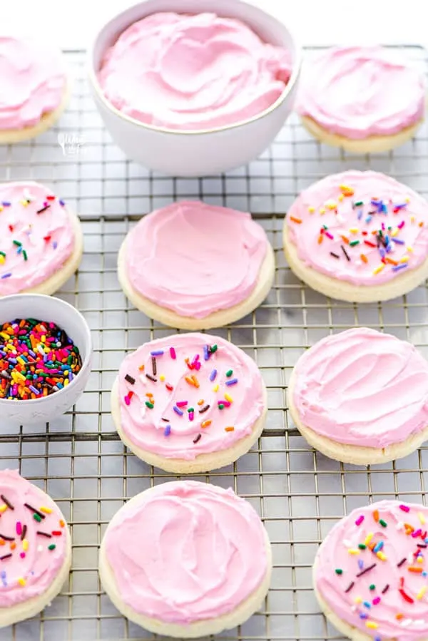 Cut out no chill Gluten Free Frosted Sugar Cookies are a must-make. Frost them and top them with sprinkles for a gluten free dessert recipe that’s perfect for a party or for the holidays. You can decorate them with royal icing if you prefer! Gluten free and dairy free cookie recipe from @whattheforkblog - visit www.whattheforkfoodblog.com for more easy gluten free desserts and gluten free cookies! #glutenfree #dairyfree #sugarcookies #frostedsugarcookies #cutoutsugarcookies #glutenfreecookies