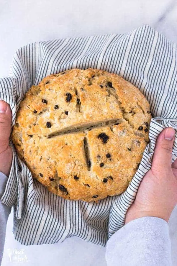 hands holding gluten free Irish Soda Bread for St. Patrick's Day