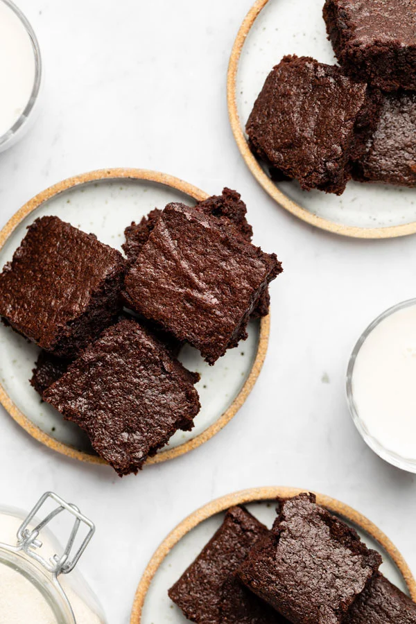 overhead shot of fudgy gluten free brownies on 3 different small plates