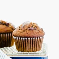 Gluten Free Pumpkin Chocolate Chip Muffins cooling on a wire rack and cutting board