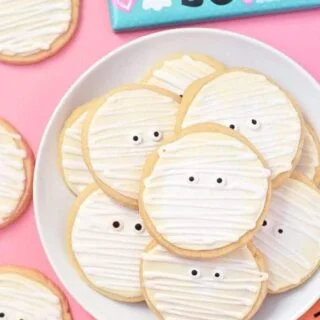 Gluten Free Mummy Cookies are a fun treat for Halloween parties. Made with gluten free and dairy free sugar cookies and an easy royal icing for decorating. Recipe from @whattheforkblog | whattheforkfoodblog.com