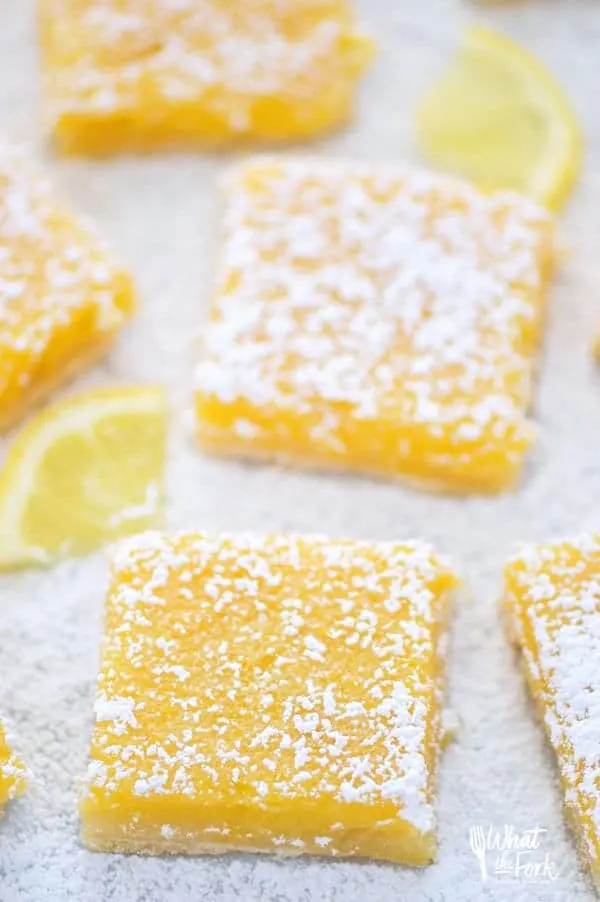 Easy and delicious gluten free lemon squares. They're not too tangy and just sweet enough! Perfect for Easter, bridal showers, baby showers, or any dessert table. Recipe from @whattheforkblog | whattheforkfoodblog.com | Sponsored | lemon bars | gluten free desserts | easy gluten free recipes | Spring desserts | lemon custard with shortbread crust | best recipes | gluten free baking