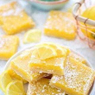 Easy and delicious gluten free lemon squares. They're not too tangy and just sweet enough! Perfect for Easter, bridal showers, baby showers, or any dessert table. Recipe from @whattheforkblog | whattheforkfoodblog.com | lemon bars | gluten free desserts | easy gluten free recipes | Spring desserts | lemon custard with shortbread crust #glutenfree #dessert #lemon #lemonbars