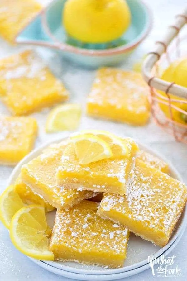 Easy and delicious gluten free lemon squares. They're not too tangy and just sweet enough! Perfect for Easter, bridal showers, baby showers, or any dessert table. Recipe from @whattheforkblog | whattheforkfoodblog.com | Sponsored | lemon bars | gluten free desserts | easy gluten free recipes | Spring desserts | lemon custard with shortbread crust | best recipes | gluten free baking