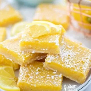 Easy and delicious gluten free lemon squares. They're not too tangy and just sweet enough! Perfect for Easter, bridal showers, baby showers, or any dessert table. Recipe from @whattheforkblog | whattheforkfoodblog.com | lemon bars | gluten free desserts | easy gluten free recipes | Spring desserts | lemon custard with shortbread crust #glutenfree #dessert #lemon #lemonbars