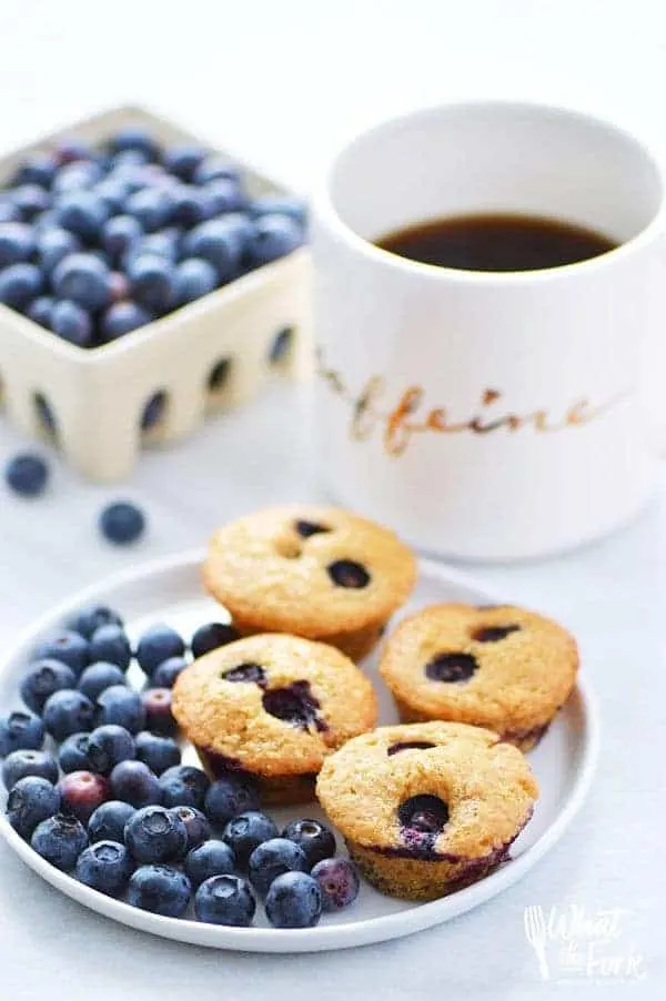 Quick and easy Gluten Free Mini Blueberry Muffins make a great grab-and-go breakfast or snack. Recipe from @whattheforkblog | whattheforkfoodblog.com | gluten free breakfast recipes | blueberry mini muffins | blueberry muffins recipe | muffin recipes | best blueberry muffins | homemade blueberry muffins | dairy free muffin recipes | gluten free muffins |