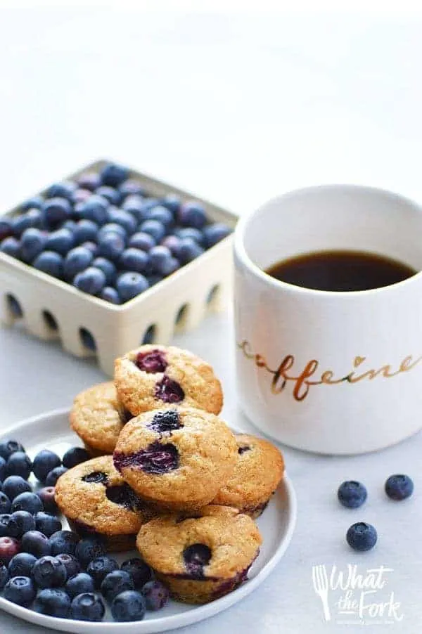 Quick and easy Gluten Free Mini Blueberry Muffins make a great grab-and-go breakfast or snack. Recipe from @whattheforkblog | whattheforkfoodblog.com | gluten free breakfast recipes | blueberry mini muffins | blueberry muffins recipe | muffin recipes | best blueberry muffins | homemade blueberry muffins | dairy free muffin recipes | gluten free muffins | 