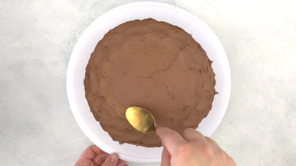 use spoon to make designs on gf chocolate cake