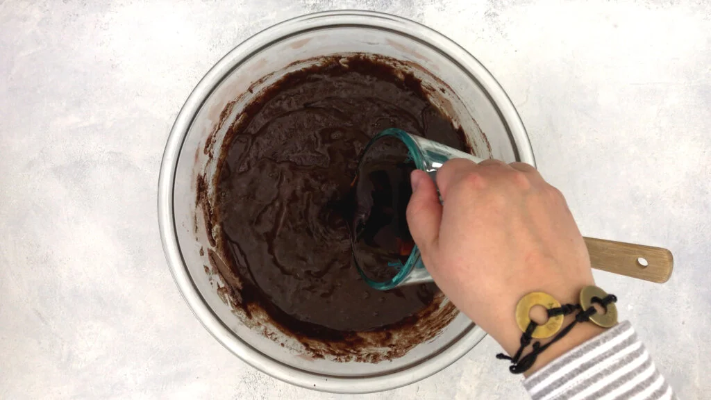 Scrape down the sides and bottom of the bowl to get all of the cake batter and pour in the hot coffee. Mix on low until incorporated.