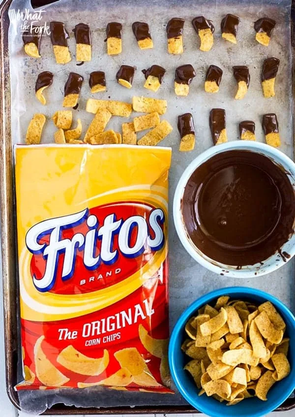 Chocolate Dipped Fritos (aka Fritos Jets) are a delicious salty-sweet snack! They're great for parties! Easy recipe from @whattheforkblog | whattheforkfoodblog.com | gluten free snacks | appetizers | chocolate covered | sweet and salty | chips | Sponsored by Frito Lay | snack foods | easy snacks | no-bake recipes