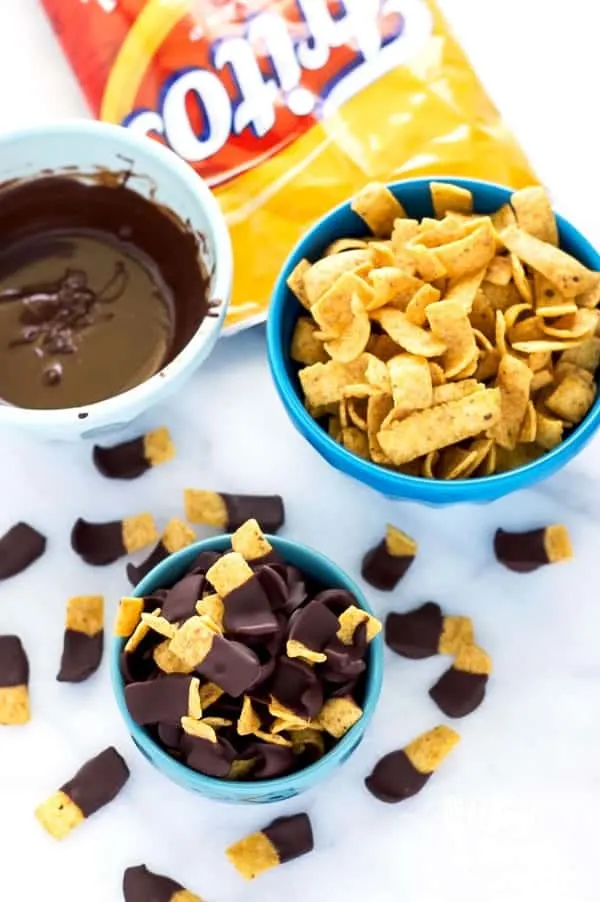 Chocolate Dipped Fritos (aka Fritos Jets) are a delicious salty-sweet snack! They're great for parties! Easy recipe from @whattheforkblog | whattheforkfoodblog.com | gluten free snacks | appetizers | chocolate covered | sweet and salty | chips | Sponsored by Frito Lay | snack foods | easy snacks | no-bake recipes