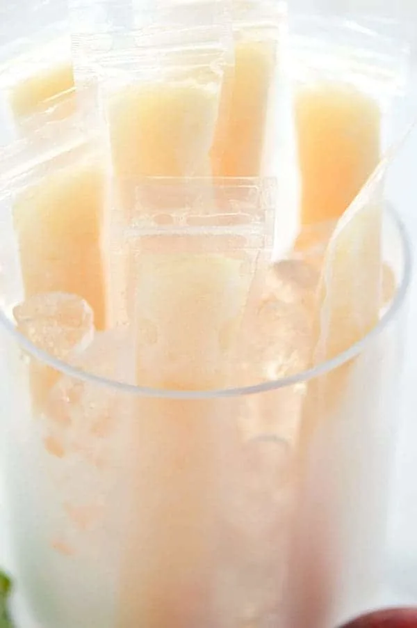 How to make your own Peach Prosecco Popsicles - so easy! These trendy frozen cocktails can be made with minimal ingredients and are ready for the freezer in just 5 minutes. Recipe from @whattheforkblog | whattheforkfoodblog.com | Sponsored by Riondo Prosecco | poptails | poptail recipes | frozen cocktails | boozy popsicles | frozen Bellinis | easy cocktail recipes | easy popsicle recipes