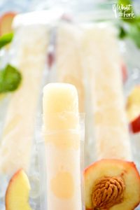 How to make your own Peach Prosecco Popsicles - so easy! These trendy frozen cocktails can be made with minimal ingredients and are ready for the freezer in just 5 minutes. Recipe from @whattheforkblog | whattheforkfoodblog.com | Sponsored by Riondo Prosecco | poptails | poptail recipes | frozen cocktails | boozy popsicles | frozen Bellinis | easy cocktail recipes | easy popsicle recipes