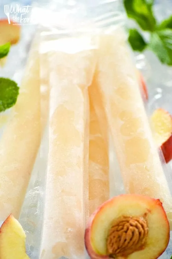 How to make your own Peach Prosecco Popsicles - so easy! These trendy frozen cocktails can be made with minimal ingredients and are ready for the freezer in just 5 minutes. Recipe from @whattheforkblog | whattheforkfoodblog.com | Sponsored by Riondo Prosecco | poptails | poptail recipes | frozen cocktails | boozy popsicles | frozen Bellinis | easy cocktail recipes | easy popsicle recipes