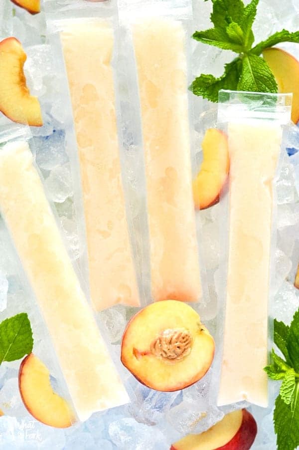 How to make your own Peach Prosecco Popsicles - so easy! These trendy frozen cocktails can be made with minimal ingredients and are ready for the freezer in just 5 minutes. Recipe from @whattheforkblog | whattheforkfoodblog.com | Sponsored by Riondo Prosecco | poptails | poptail recipes | frozen cocktails | boozy popsicles | frozen Bellinis | easy cocktail recipes | easy popsicle recipes