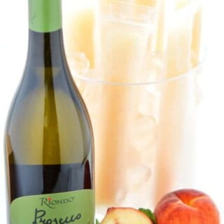 How to make your own Peach Prosecco Popsicles - so easy! These trendy frozen cocktails can be made with minimal ingredients and are ready for the freezer in just 5 minutes. Recipe from @whattheforkblog | whattheforkfoodblog.com | Sponsored by Riondo Prosecco | poptails | poptail recipes | frozen cocktails | boozy popsicles | frozen Bellinis | easy cocktail recipes | easy popsicle recipes