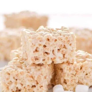 Classic Gluten Free Rice Krispies Treats - these are a crowd-pleasing favorite! They're so easy to make and have such a great gooey marshmallow to cereal ratio - they're simply addicting! Dessert recipe from @whattheforkblog | whattheforkfoodblog.com | gluten free desserts | no-bake dessert recipes | how to make rice krispie treats | gluten free no-bake recipes | easy dessert recipes | homemade rice krispies treats | marshmallow recipes | desserts for a bake sale | classic dessert recipes