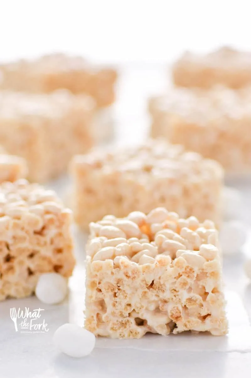 Classic Gluten Free Rice Krispies Treats - these are a crowd-pleasing favorite! They're so easy to make and have such a great gooey marshmallow to cereal ratio - they're simply addicting! Dessert recipe from @whattheforkblog | whattheforkfoodblog.com | gluten free desserts | no-bake dessert recipes | how to make rice krispie treats | gluten free no-bake recipes | easy dessert recipes | homemade rice krispies treats | marshmallow recipes | desserts for a bake sale | classic dessert recipes