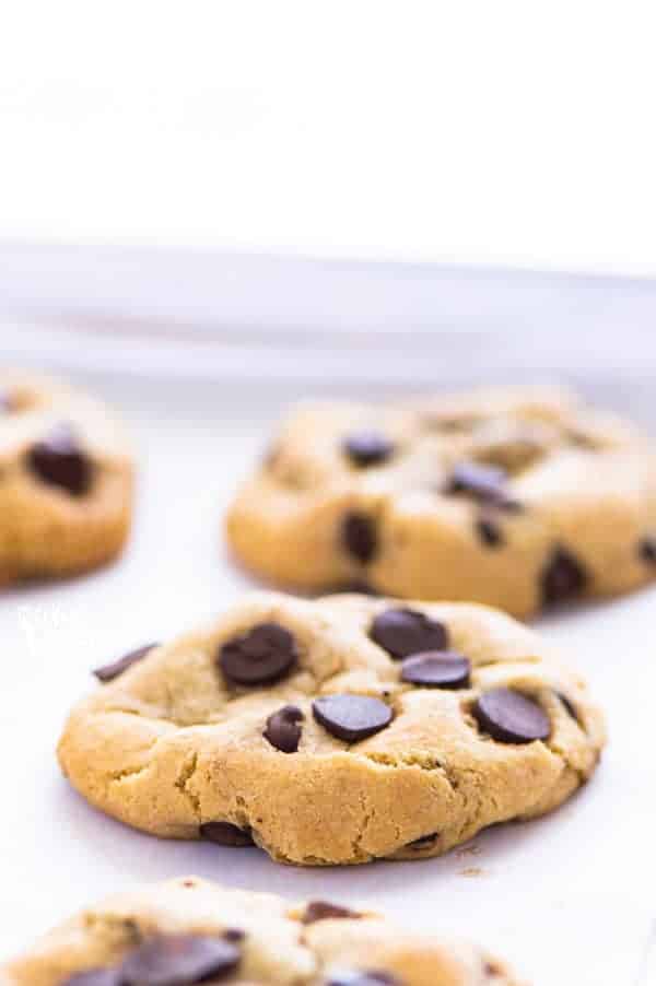 These are the best gluten free chocolate chip cookies you’ll ever have! They’re buttery, soft in the middle yet firm enough to dunk in a glass of milk. They’ve got chewy edges and are filled with melt in your mouth chunks of chocolate. Easy to make too! Recipe from @whattheforkblog | whattheforkfoodblog.com | Sponsored | gluten free cookie recipes | homemade cookies | bakery style cookies | gluten free dessert recipes #glutenfree #glutenfreecookies #chocolate #chocolatechipcookies #dessert