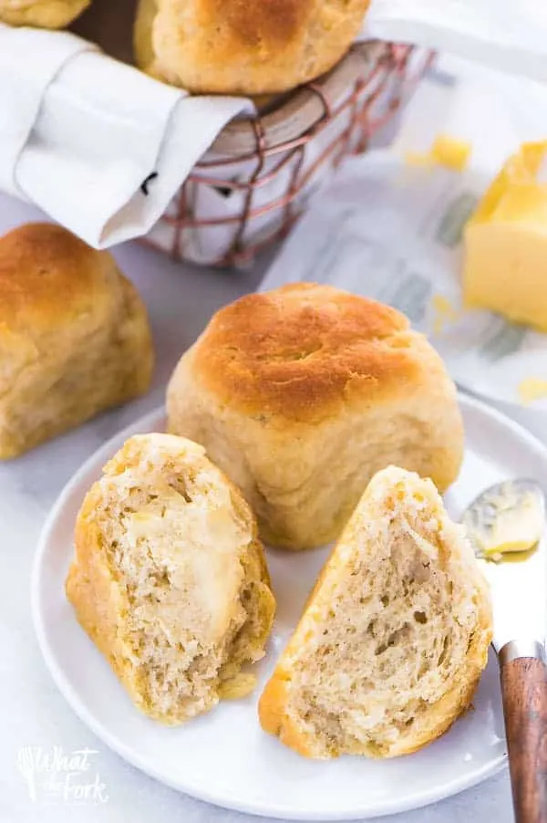 Two GF dinner rolls with butter spread on them