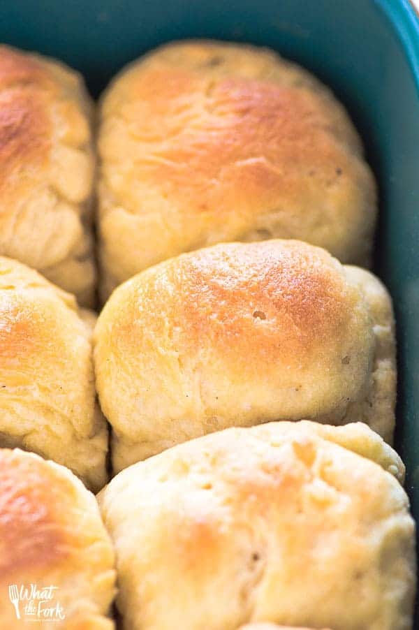 Delicious, golden gluten free dinner rolls in a baking pan