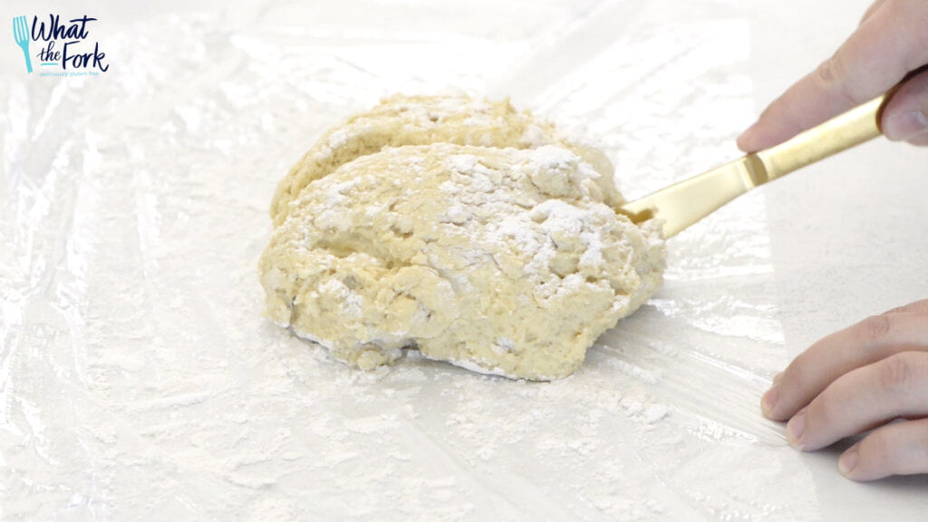 Sprinkle flour on top of dough and begin to cut into 8 equal sized pieces.