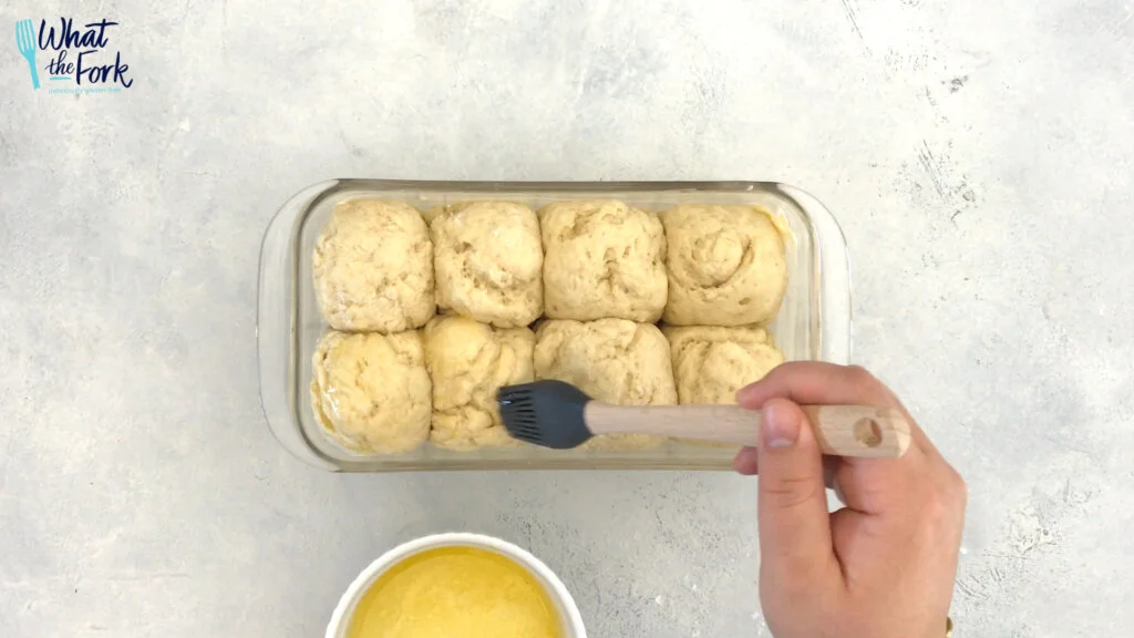 Brush tops the of rolls with 1 tablespoon of butter.  Then, bake the rolls 20-24 minutes until golden brown.